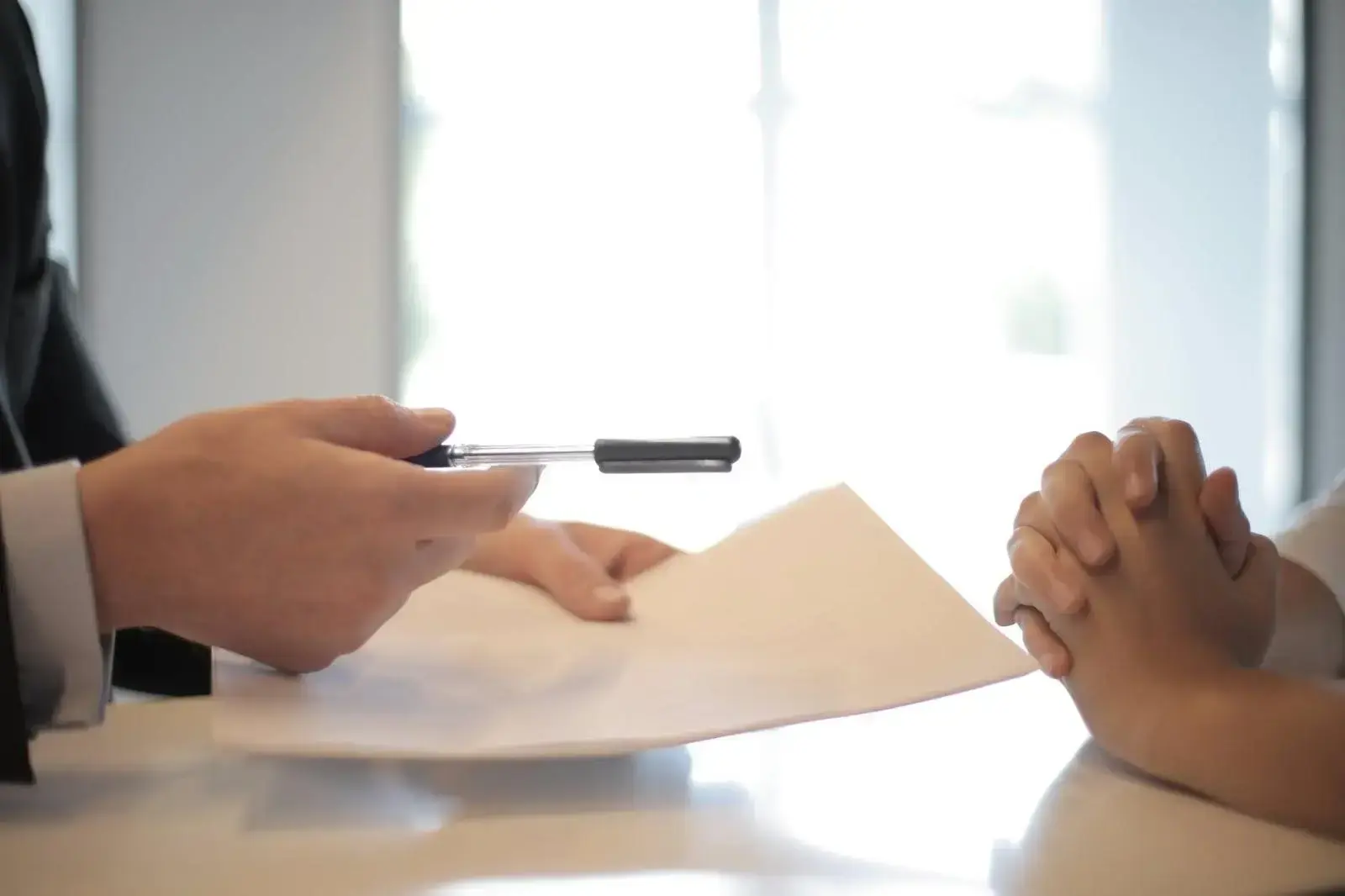 Picture 4 A man gives estate planning documents to a woman for signing